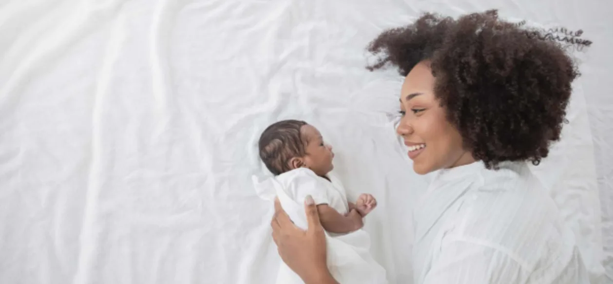 closeup portrait African American mother and newborn baby postpartum retreat